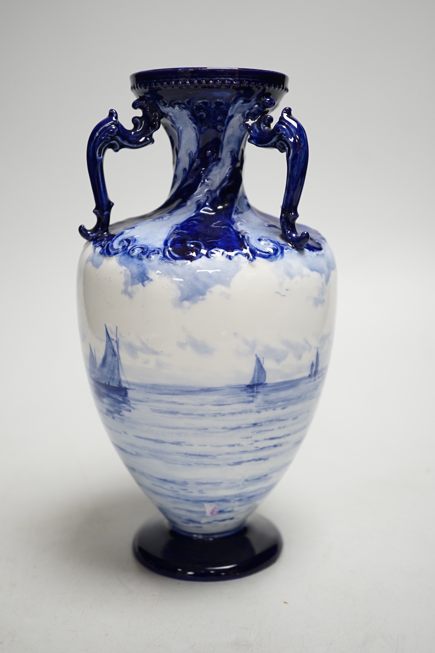 A Royal Crown Derby blue and white vase painted with shipping scenes by WEJ Dean. 22cm tall